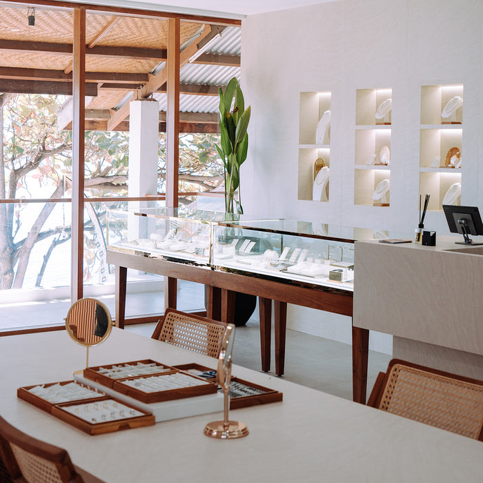 Elegant interior with jewelry display and large windows.