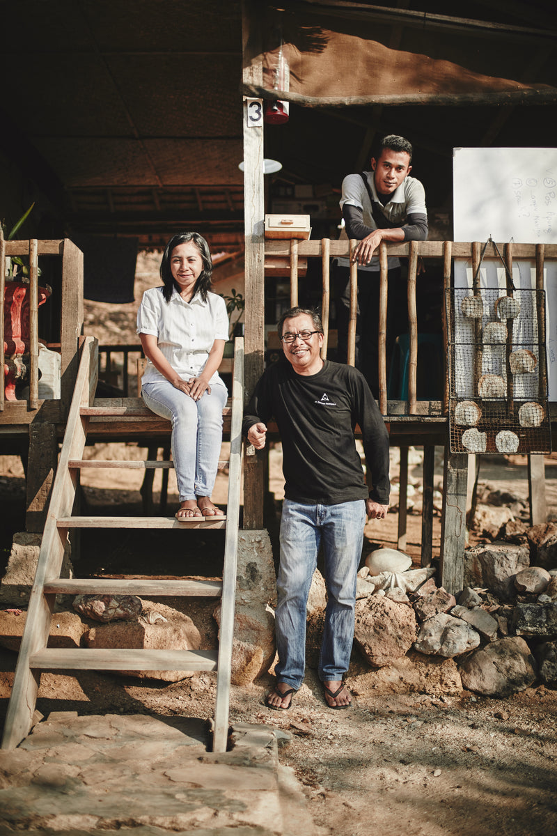 3 people standing and sitting at a balcony entrance