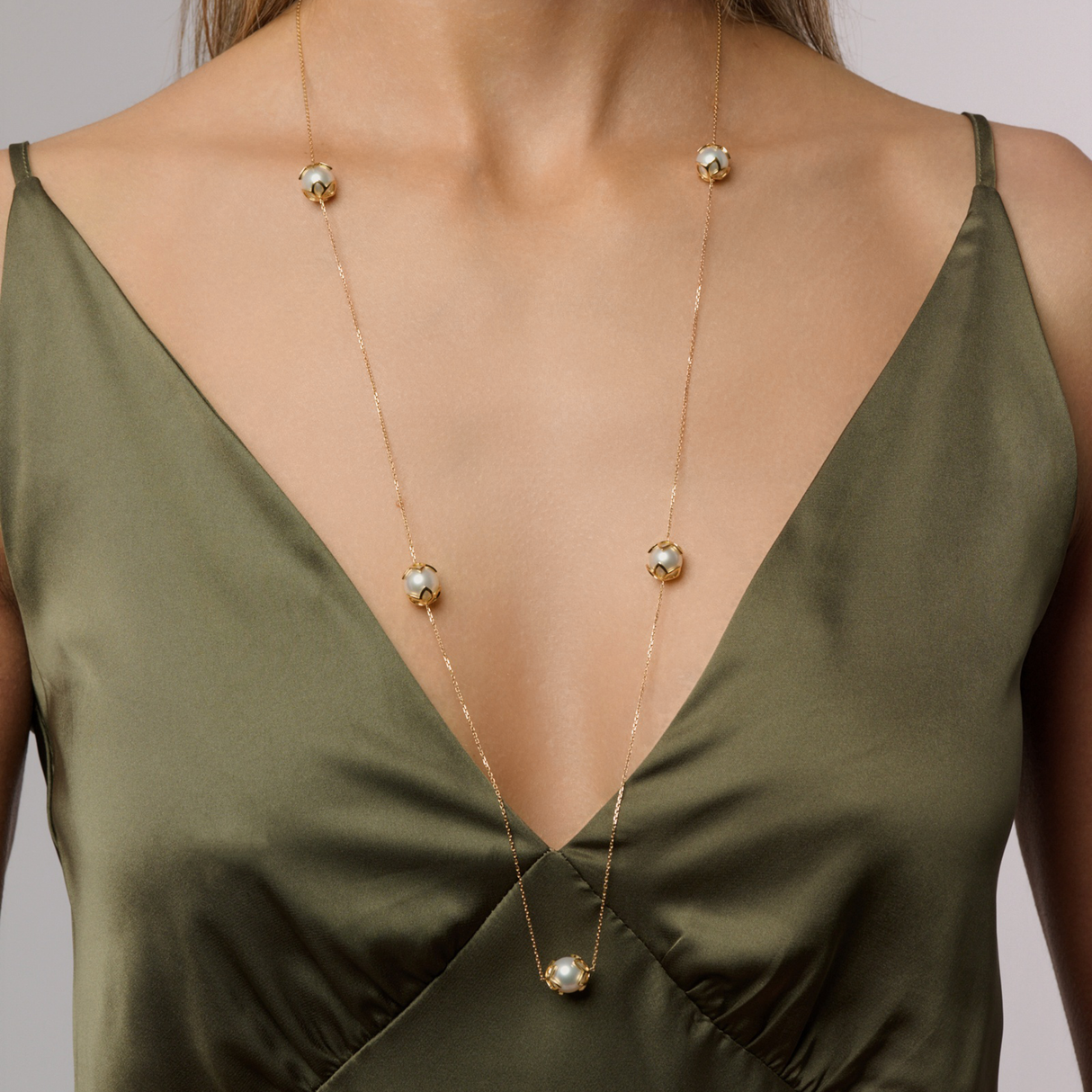 On model This station necklace features five 9mm semi-round South Sea pearls set in 18K white gold frangipani cups. The 90cm chain is adjustable to 80cm, offering flexibility for various looks. Perfect for adding elegance and sophistication to any ensemble.