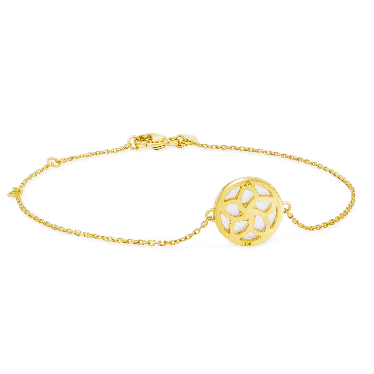 A gold bracelet with a central mother of pearl shell detail surrounded by a blue sapphire on one side, displayed against a white background.