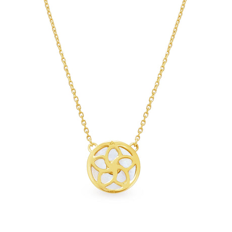 A 18K yellow gold necklace with a circular mother of pearl pendant and blue sapphire accents on a chain.