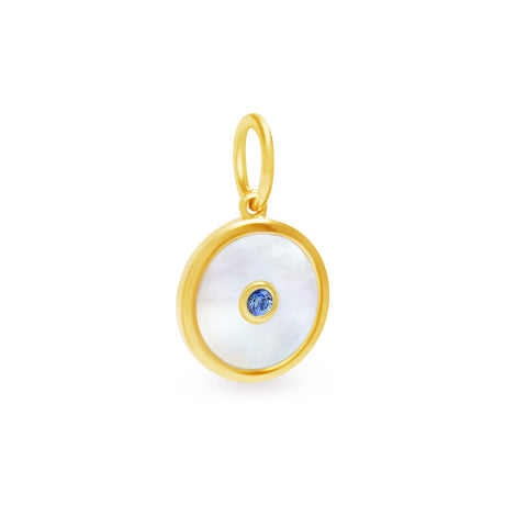 A round pendant with a yellow gold finish, featuring a mother of pearl shell in the center with a small blue sapphire embedded towards the bottom.