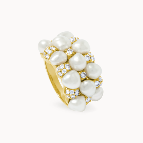 Gold ring with pearls and small diamonds on a white background