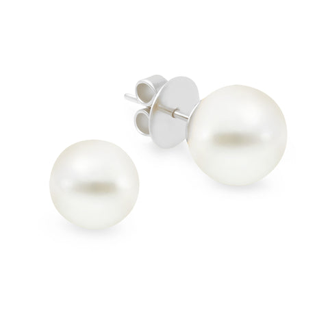 A pair of pearl stud earrings with high button shape, set in 18K white gold.