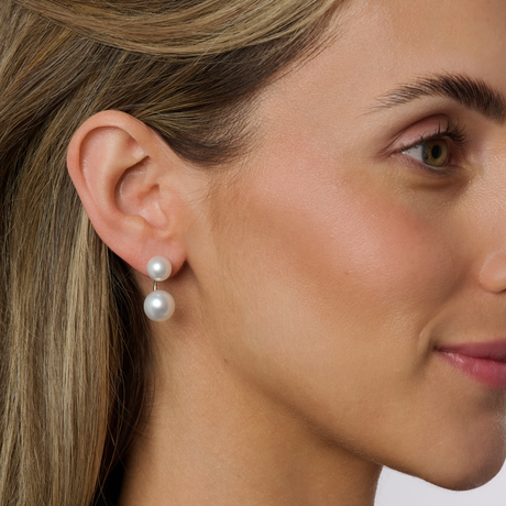 Woman's side profile modelling a dobble pearl stud earring.