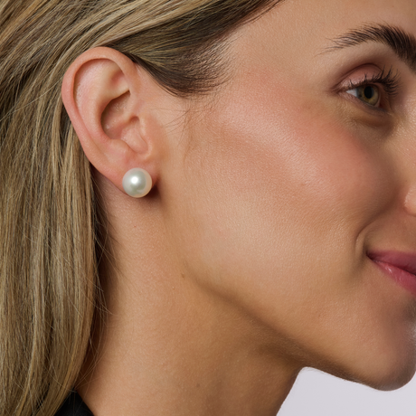 On model Flat Button (BF) pearls are a popular and accessible choice, often appearing round from the front but flatter in shape. These earrings are available in 18K white or yellow gold, as well as Sterling Silver, with sizes ranging from 9mm to 12mm. Due to their shape and availability, Flat Button studs are highly sought after, offering a balance of elegance and affordability.