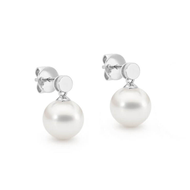 These sterling silver earrings feature two 9mm drop-shaped South Sea pearls on a sterling silver disc. The pearls are white and graded as "C1." The earrings are designed with articulation for added movement.