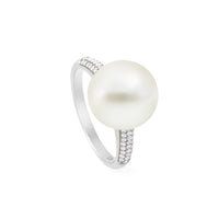 A 9K white gold ring with a prominent South Sea pearl and diamond paved shoulders.