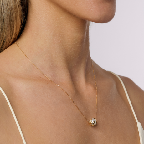 On model This necklace features 9mm semi-round South Sea pearls set in 18K yellow gold frangipani cups. The adjustable 50cm chain can be worn at lengths of 47.5cm, 45cm, or 42.5cm, making it versatile for different occasions. It combines timeless elegance with the harmony of nature, perfect for various styling preferences.