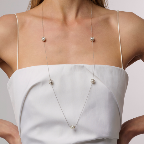 On model This station necklace features five 9mm semi-round South Sea pearls set in 18K white gold frangipani cups. The 90cm chain is adjustable to 80cm, offering flexibility for various looks. Perfect for adding elegance and sophistication to any ensemble.