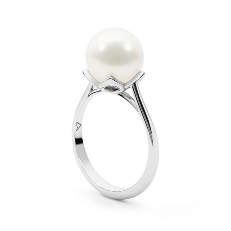 This 18K white gold ring showcases a 9mm semi-round white South Sea pearl (B2 grade) with a flower detail cupping the pearl, perfect for adding elegance to any look. Available in USA sizes 6, 7, and 8, it makes a timeless addition to your collection.