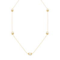 This station necklace features five 9mm semi-round South Sea pearls set in 18K yellow gold frangipani cups. The 90cm chain is adjustable to 80cm, offering flexibility for various looks. Perfect for adding elegance and sophistication to any ensemble.
