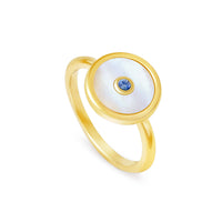 A ring with 18K yellow gold finish, featuring a mother of pearl shell with a blue sapphire in the center.