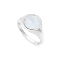 A silver ring with a round mother of pearl shell inset, displayed against a white background.