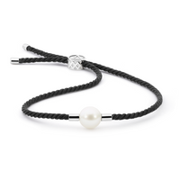 Elegant bracelet featuring a 10mm South Sea pearl embraced by handwoven black Japanese silk cord, symbolizing clarity and focus. The pearl's pristine beauty represents sustainable, biodiverse waters, inspired by the midnight seas where Atlas farms are located.