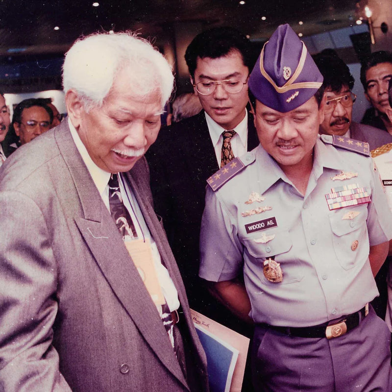 Two men mid conversation man on left is a founder of Atlas Pearls. The man on the right is a naval dignitary wearing military uniform. 