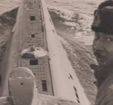 Old black and white image of man on submarine 
