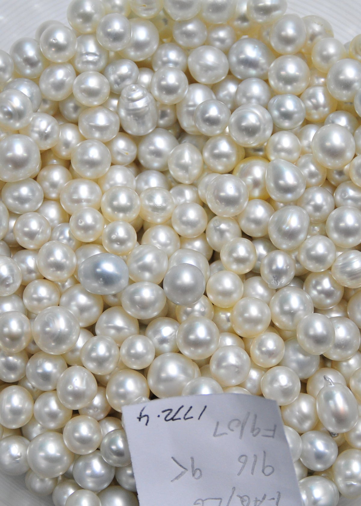 Bulk collection of white cultured pearls in various shapes and sizes