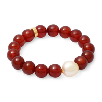 Bracelet with red beads and a pearl on a white background