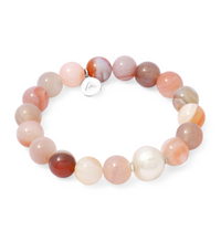 Beaded bracelet with pink beads and a white pearl on a white background