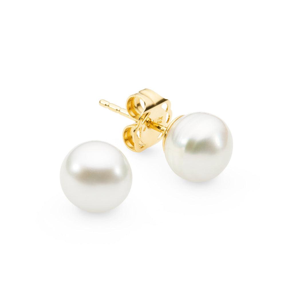 These 18K Yellow Gold Keshi Pearl earrings feature South Sea pearls in sizes 04mm, 05mm, or 06mm. Keshi pearls are irregularly shaped, creating a unique and delicate appearance. The natural process of their creation involves the oyster rejecting the nucleus, yet still producing these beautiful, small, solid pearls in a soft white hue