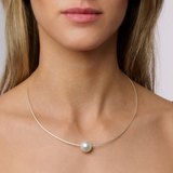 on model This pendant features a 12mm NL2 South Sea pearl with a C-grade and a white/fancy colour. The pearl is set in 925 Sterling Silver, offering both durability and shine. The design balances classic and contemporary elements, and the pendant comes with a 46cm chain to sit perfectly on your neckline. It's an elegant, eye-catching piece ideal for special occasions.