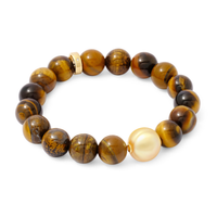 Beaded bracelet with orange mixed beads and a white pearl on a white background