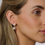 On model These Double Pearl Stud Earrings in 9K Yellow Gold feature South Sea pearls in two sizes (8mm & 10mm) for a refined look. The earrings combine round, semi-round, and baroque shapes, offering a unique design that adds timeless sophistication to any outfit. The pristine white pearls enhance their elegance, making them perfect for any occasion.