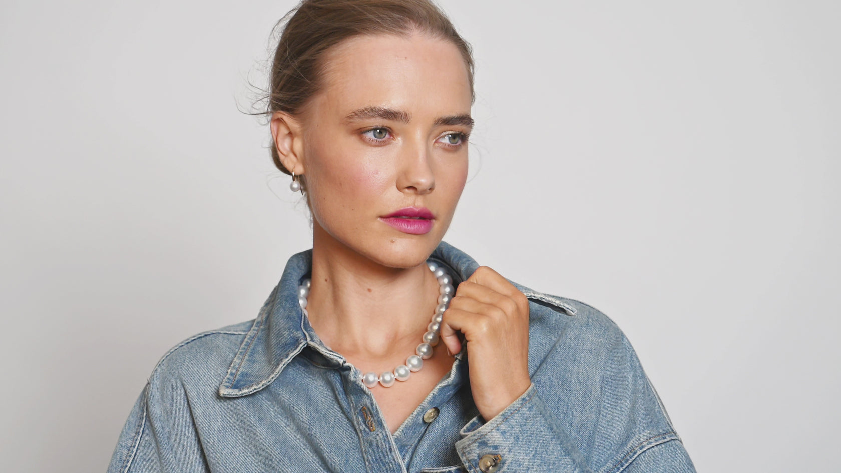 Model, wearing multiple different outfits and different pearls. In a studio on white background. 